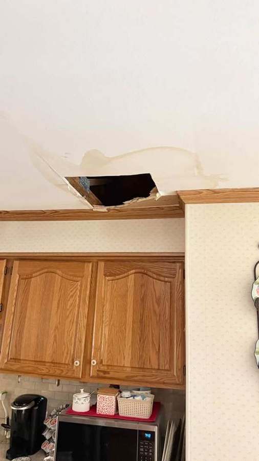 Ceiling opened for water-damage repair above kitchen cabinets
